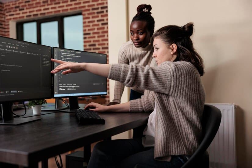 caucasian-network-developer-pointing-out-high-usage-processing-power-mainframe-grid-african-american-programmer-helping-coworker-solve-overloaded-system-storage-space_482257-40526